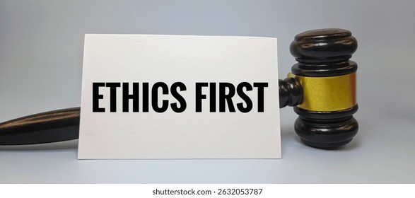 White Paper with Text Ethics First and Judge’s Gavel – Concept of Moral Justice, Legal Integrity, Fair Decision, Ethical Law, and Responsibility in Legal System. 