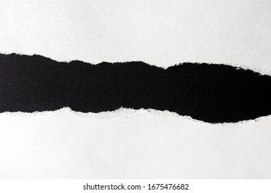 White paper with torn edges isolated with black colored paper background inside. Good paper texture