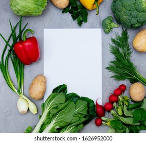 White paper and vegetables on a table. Above view 