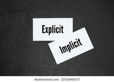white paper with the words explicit and implicit. motivational words positive and negative
