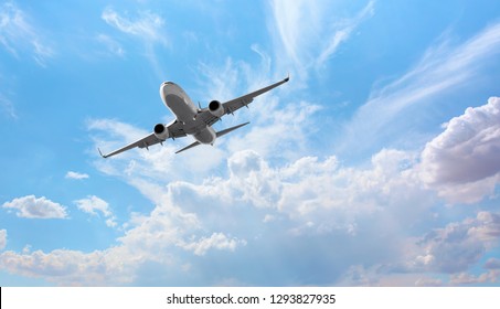 White passenger airplane flying in the sky amazing clouds in the background - Travel by air transport - Shutterstock ID 1293827935