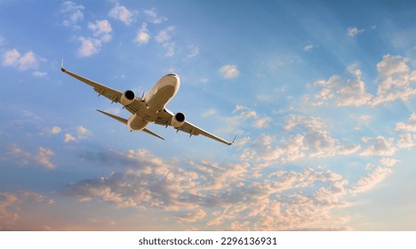 White passenger airplane flying in the sky amazing clouds in the background - Travel by air transport - Powered by Shutterstock