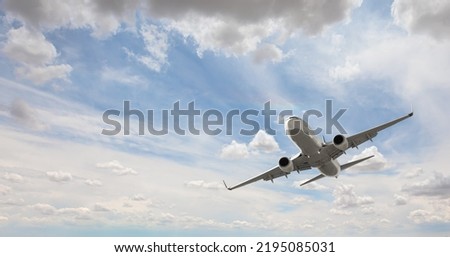 White passenger airplane flying in the sky amazing clouds in the background - Travel by air transport Foto stock © 