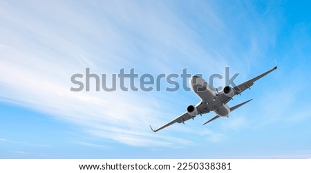 White passenger airplane flying in the sky amazing clouds in the background - Travel by air transport