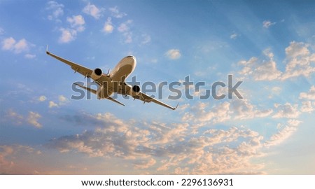White passenger airplane flying in the sky amazing clouds in the background - Travel by air transport