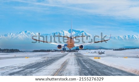 White passenger airplane landing on snowy airport - Oslo, Norway