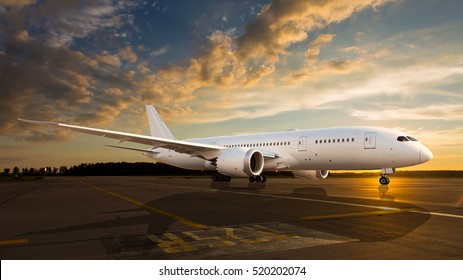 White passenger airplane on the airport runway. The plane is taking off during a colorful sunset.