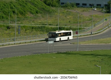 White passenger bus on a country road on a summer day. Passenger transportation by road. - Shutterstock ID 2036706965