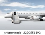 White passenger jet plane with boarding stairs isolated on bright background with sky