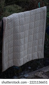 White pattern square, blanket. Hanging on the fence. Forsaken object. - Shutterstock ID 2221136651