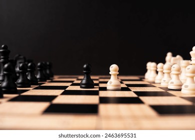 White pawn chess face off with black pawn chess black background - Powered by Shutterstock