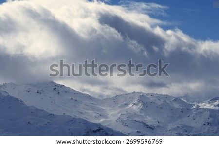 White Peak Beneath a Brooding Ceiling