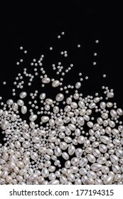 White Pearls On The Black Background. Composition Of Different Shaped Natural Fresh Water Pearls.