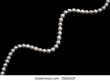 White pearls on the black silk can use as background