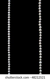 White pearls on the black silk as background