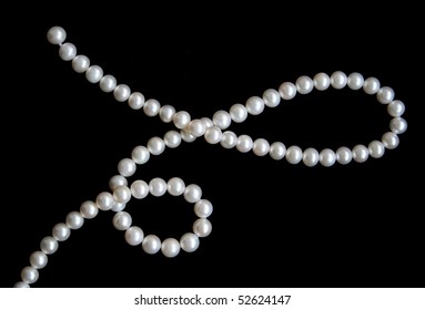 White pearls on the black velvet background