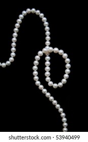 White pearls on the black velvet background