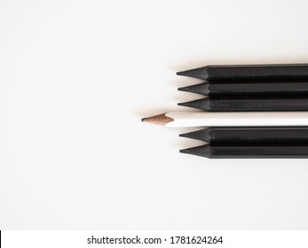 White Pencil Standing Out Same Crowd Black Bold Pencils On A White Background, With Space Text. Leadership, Unique, Concept.