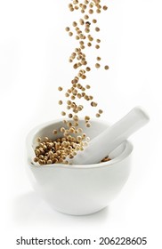 White Peppercorns Falling Into Mortar And Pestle Ob A White Background