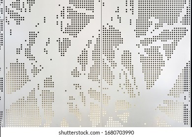 White Perforated Metal Panel With An Abstract Square Pattern. Architecture Facade Cladding Using Parametric Design And Lighting From Behind.