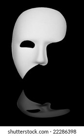White phantom of the opera half face mask isolated on black background