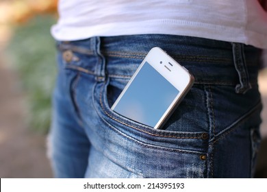 white phone in jeans pocket
