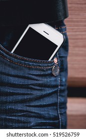 white phone in jeans pocket closeup.