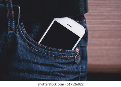 white phone in jeans pocket closeup.