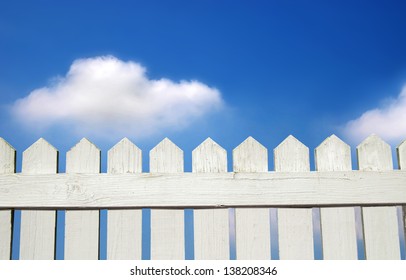 White picket fence and blue sky