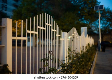 White Picket Fence On The Street At Night