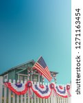 White Picket Fence USA Home With Flag And Blue Sky And Copy Space