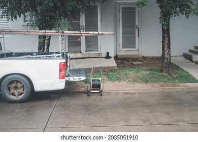 White Pickup Car With Opened Truck And Wooden Ladder And Roll Wires For Repair Wires