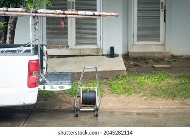 White Pickup Car With Opened Truck And Wooden Ladder And Roll Wires For Repair Wires