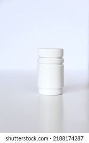 White Pill Or Vitamin Dietary Supplement Bottle, Medical Drug Plastic Bottle  On White Background.