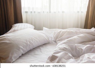 White Pillow And Blanket With Wrinkle Messy On Bed In Bedroom, Messy From Sleeping In A Long Night Winter.