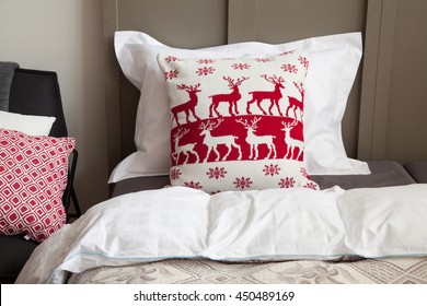 White Pillow And Pillow With Christmas Deer In Scandinavian Style On A Bed Closeup