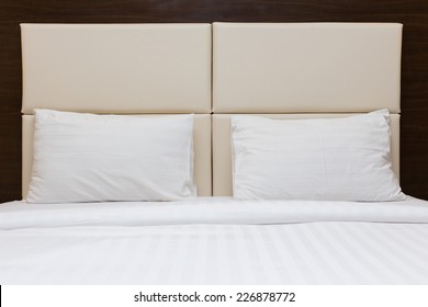 White Pillow And Leather Headboard In Bedroom
