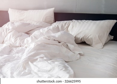 White Pillow On Bed And With Wrinkle Messy Blanket In Bedroom, From Sleeping In A Long Night.