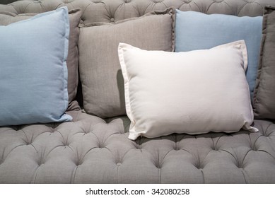 white pillow on grey sofa