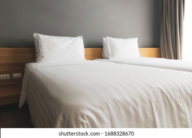 white pillows and bed of hotel room