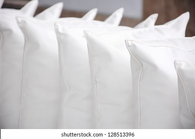 white pillows leather on cushion, a clean and light interior detail of decoration