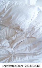 White Pillows On Crumpled Bed
