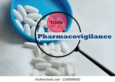 White pills close-up on a blue-white background with marked toxin, not approved a check mark approved. close-up, pharmacovigilance, safety quality control