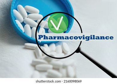White pills close-up on a blue-white background with a check mark approved. close-up, pharmacovigilance, safety quality control