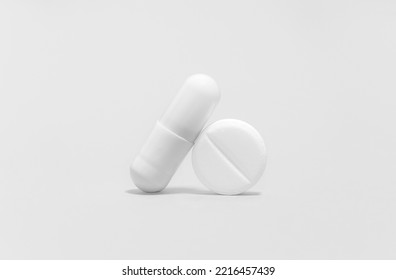 white pills isolated on white background. White tablet and capsule, painkillers as medical background. Pill for alleviating illness or fever - Shutterstock ID 2216457439