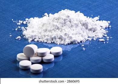 White pills with a small heap op powder in the back