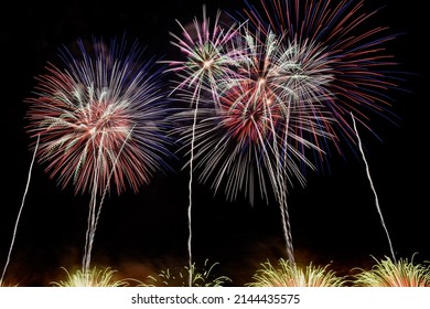 White, Pink, Green Fireworks At Night