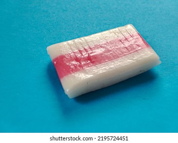 White And Pink Mint Candy Isolated On Blue Background 