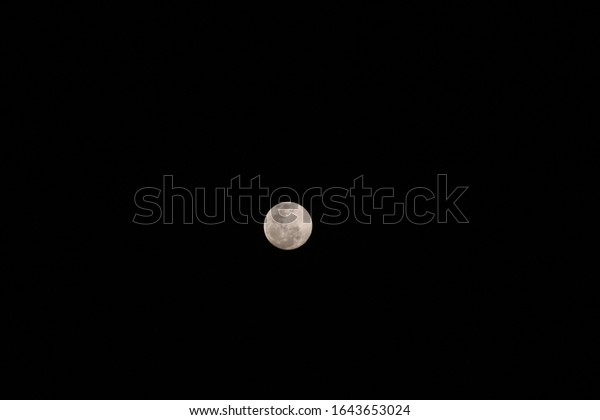 White pink moon and black
background 