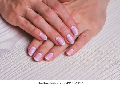 White And Pink Nail Art On The Wooden Background